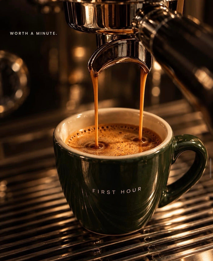 Espresso pouring into a green First Hour cup.